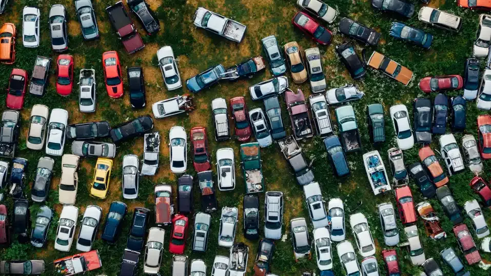 Aerial view of rows of scrapped cars at a vehicle recycling yard
